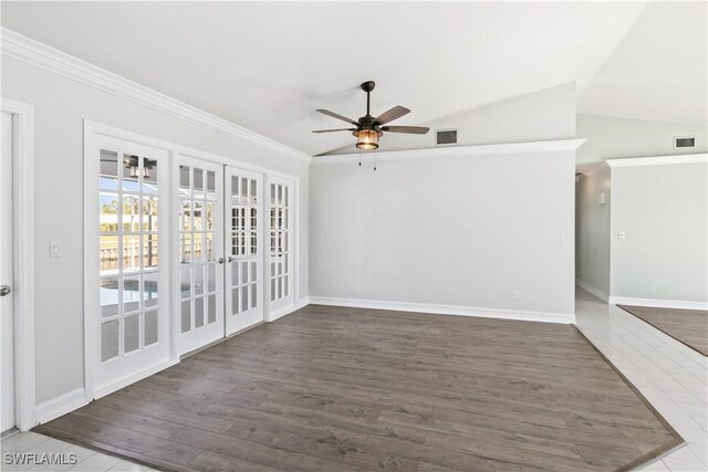 unfurnished room with lofted ceiling, ceiling fan, dark hardwood / wood-style floors, ornamental molding, and french doors