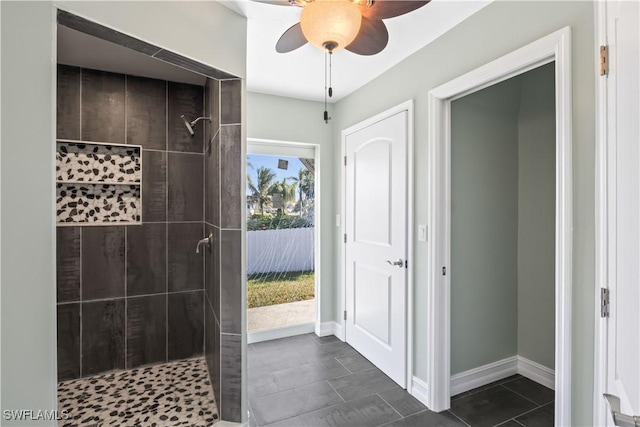 bathroom with ceiling fan and tiled shower