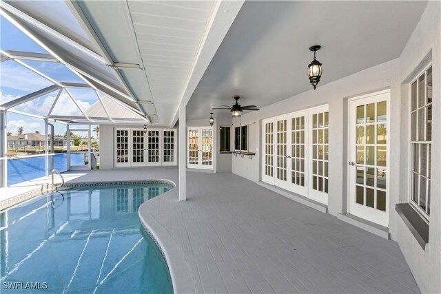 view of swimming pool with a patio, french doors, and a water view