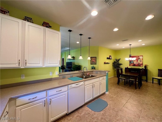 kitchen with pendant lighting, white cabinetry, sink, white dishwasher, and kitchen peninsula