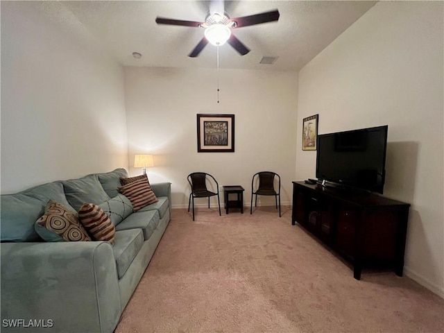 carpeted living room with ceiling fan