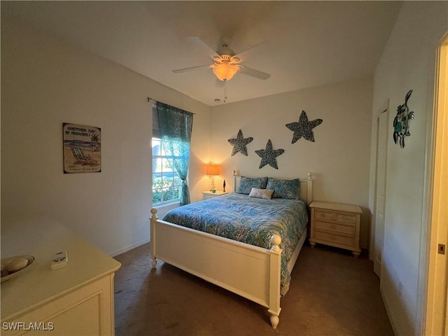 bedroom featuring ceiling fan and dark colored carpet