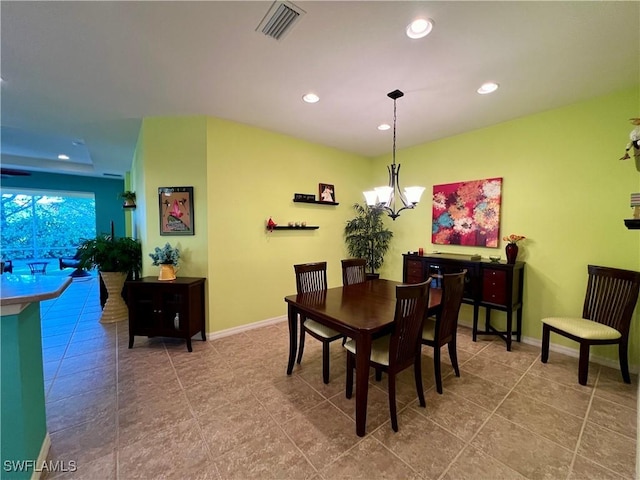 dining room featuring tile patterned floors and an inviting chandelier