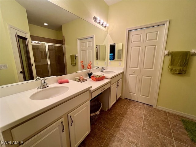 bathroom featuring tile patterned floors, vanity, and a shower with door