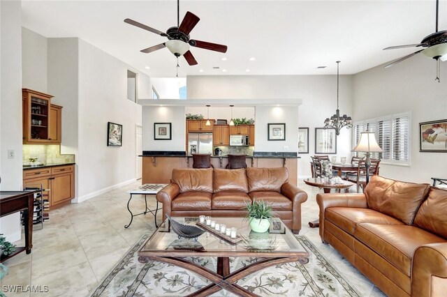 living room featuring a towering ceiling and a chandelier