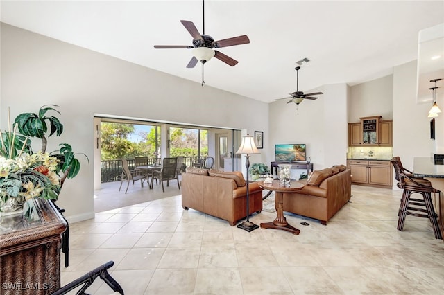 living room featuring light tile patterned flooring and ceiling fan