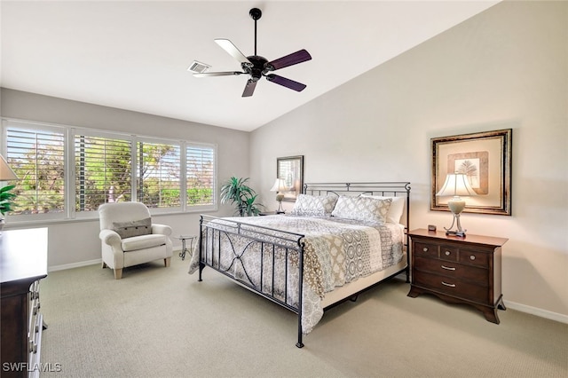 bedroom featuring ceiling fan, light colored carpet, and vaulted ceiling