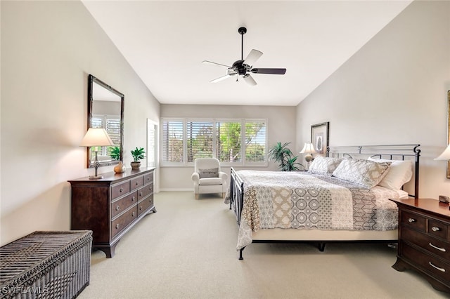 carpeted bedroom with ceiling fan and vaulted ceiling