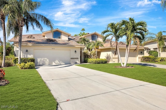 mediterranean / spanish house with a garage and a front yard