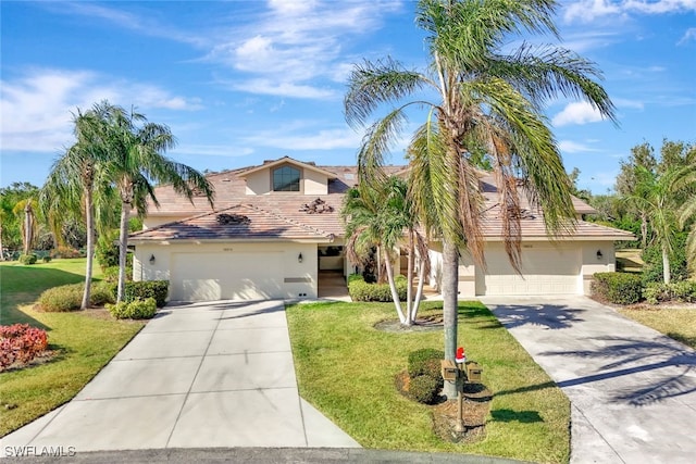 view of front facade featuring a front yard and a garage