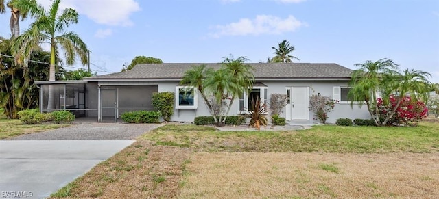 ranch-style house with a sunroom and a front yard