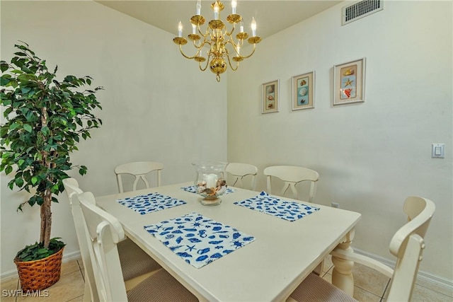 tiled dining room featuring an inviting chandelier