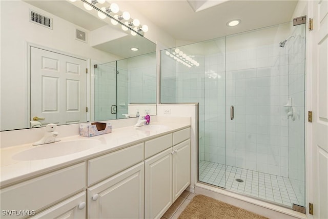 bathroom featuring tile patterned floors, vanity, and walk in shower