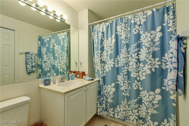 bathroom featuring tile patterned flooring, vanity, and toilet