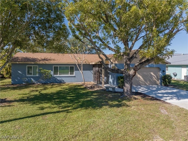 ranch-style house featuring a front yard and a garage