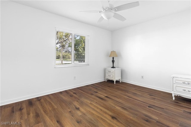 spare room with ceiling fan and dark hardwood / wood-style flooring