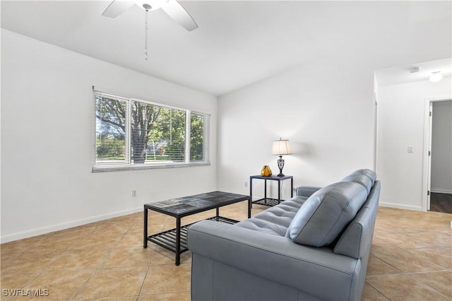 living room featuring ceiling fan, light tile patterned flooring, and vaulted ceiling