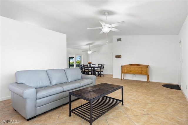 tiled living room with ceiling fan and vaulted ceiling