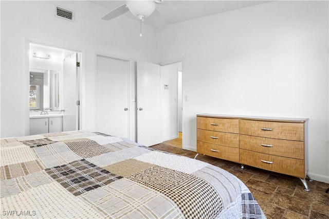 bedroom with ensuite bath and ceiling fan