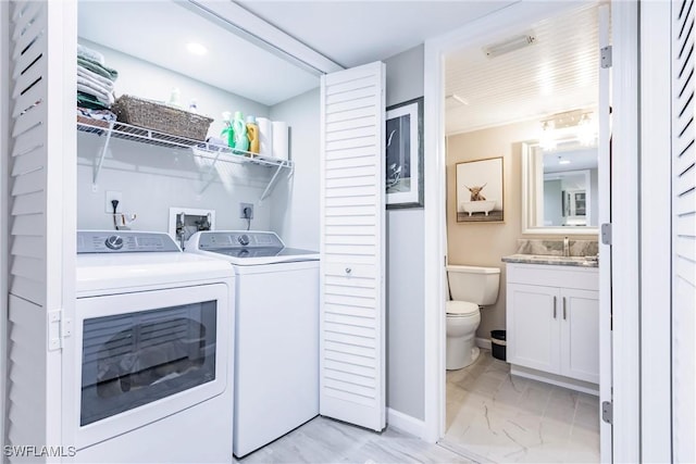 washroom featuring washer and dryer and sink