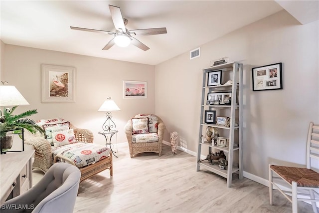 living area with ceiling fan and light wood-type flooring