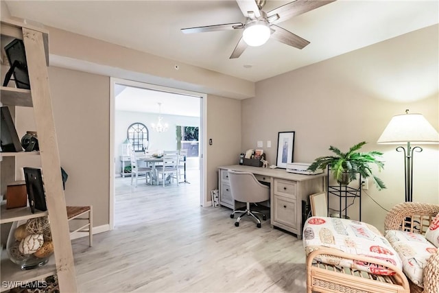 office area with light hardwood / wood-style flooring and ceiling fan with notable chandelier