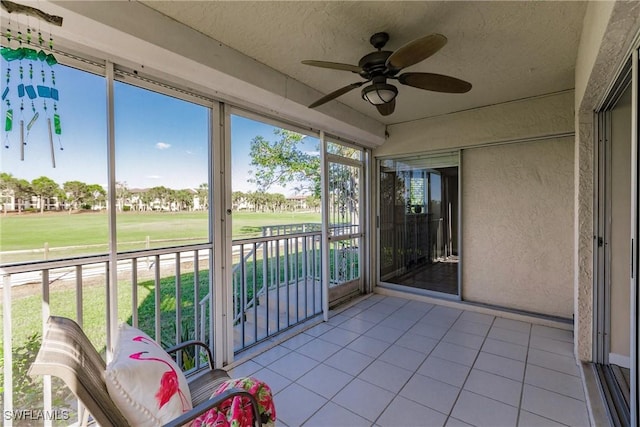 unfurnished sunroom with ceiling fan