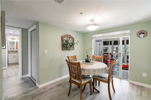 dining space featuring sink and light hardwood / wood-style flooring