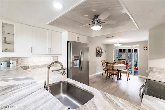 kitchen with white cabinetry, sink, ceiling fan, stainless steel fridge with ice dispenser, and range