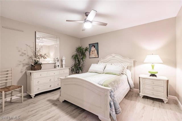 bedroom with ceiling fan and light hardwood / wood-style flooring