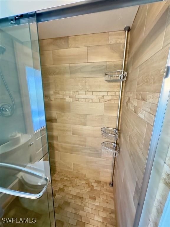 bathroom featuring a shower with shower door