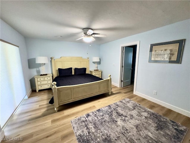 bedroom featuring light wood-type flooring and ceiling fan