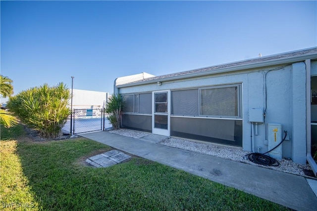 rear view of house featuring a yard