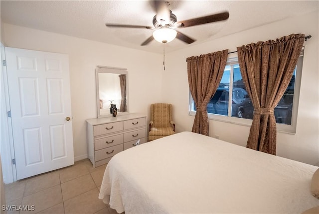 tiled bedroom featuring a textured ceiling and ceiling fan