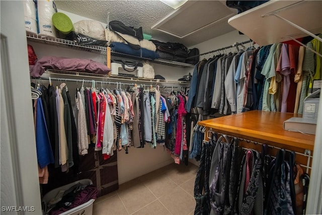 spacious closet with tile patterned floors