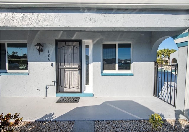 view of exterior entry featuring a porch