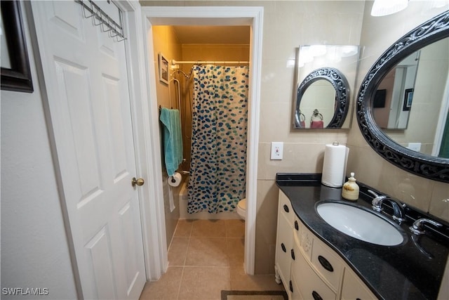 bathroom with tile patterned flooring, a shower with curtain, vanity, and toilet