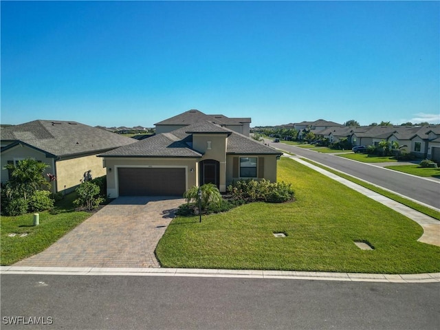 view of front of home with a front yard and a garage