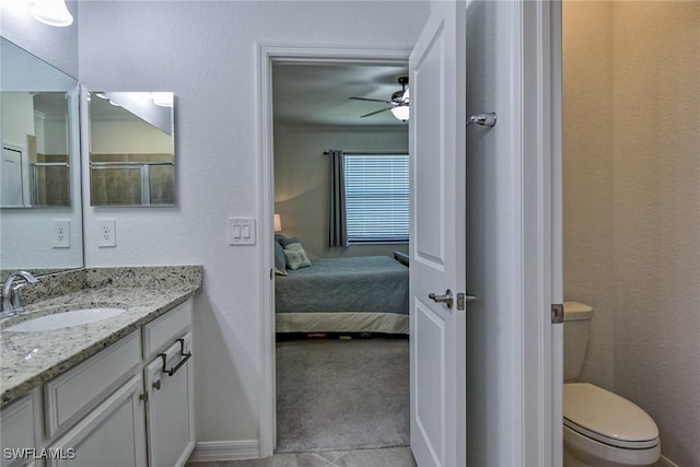 bathroom with ceiling fan, tile patterned flooring, vanity, and toilet