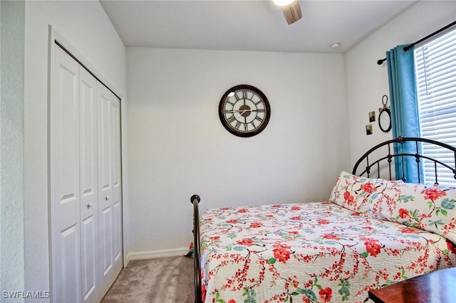 carpeted bedroom featuring ceiling fan and a closet