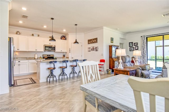 dining area featuring ornamental molding and sink