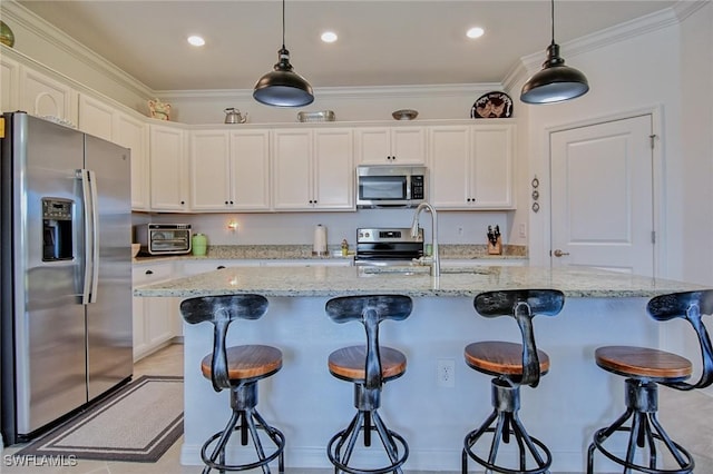 kitchen featuring white cabinetry, a center island with sink, stainless steel appliances, and sink