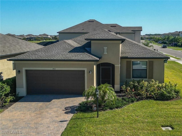 view of front of property featuring a garage and a front lawn