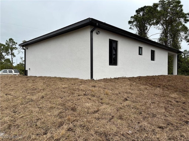 view of property exterior with a lawn