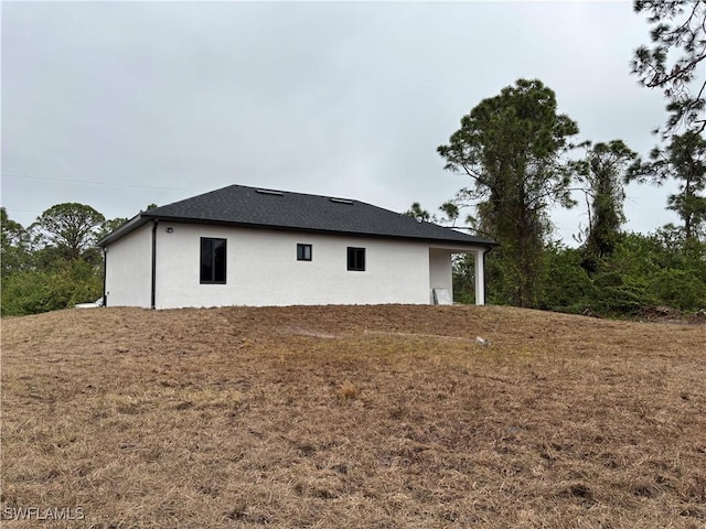 view of side of property with a lawn