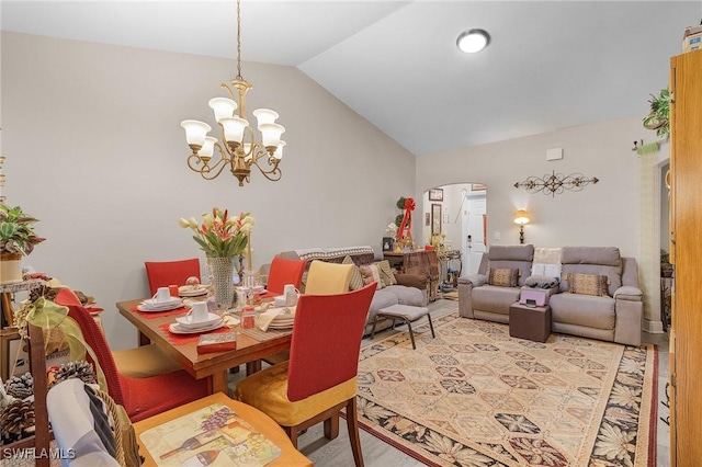 dining area with lofted ceiling and a notable chandelier