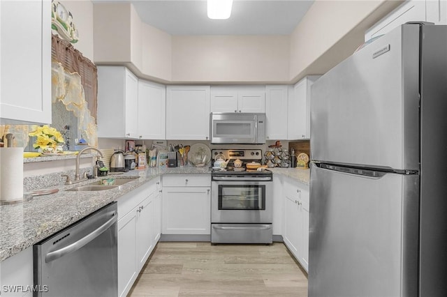 kitchen featuring light hardwood / wood-style flooring, stainless steel appliances, white cabinetry, and sink