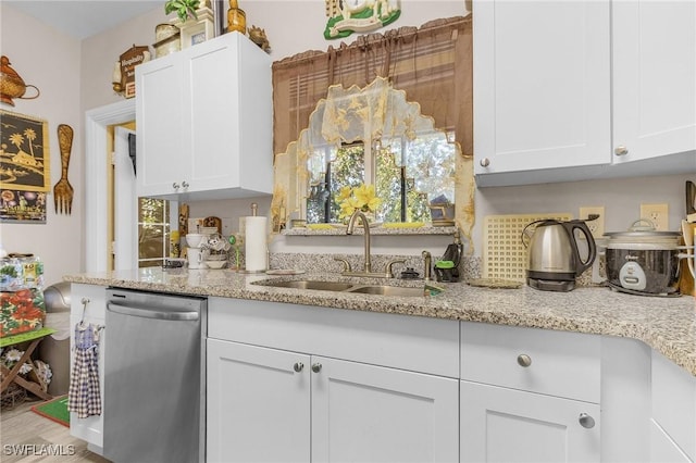 kitchen with white cabinetry, dishwasher, sink, and light stone counters