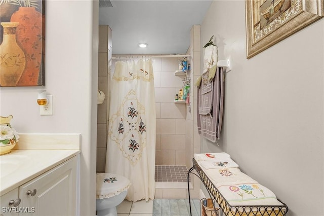 bathroom with toilet, vanity, tile patterned floors, and a shower with shower curtain