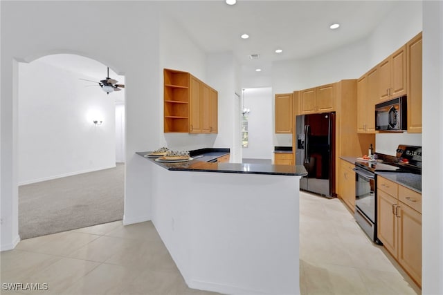 kitchen featuring kitchen peninsula, light colored carpet, ceiling fan, black appliances, and light brown cabinets